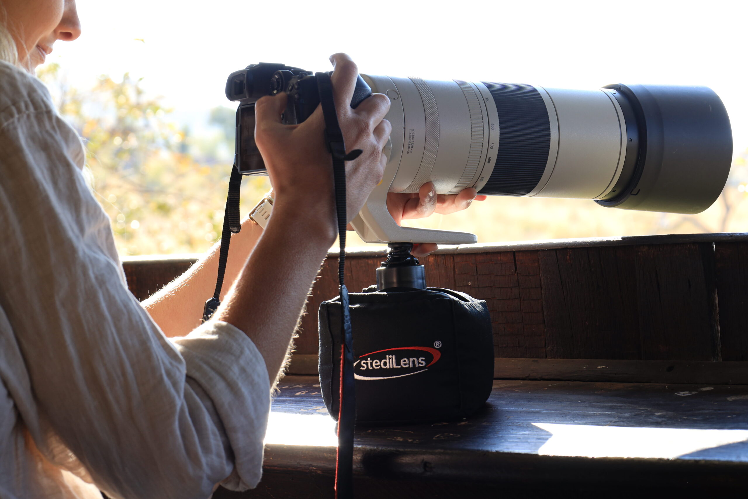 Photographer using StediLens telephoto lens support